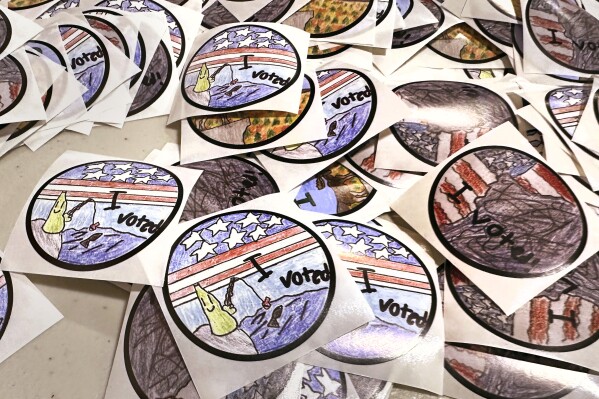 "I Voted" stickers are displayed on a table at Pinkerton Academy on Tuesday. (AP Photo/Charles Krupa)